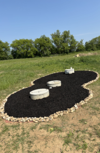 Figure eight garden with completed mulch installation in back yard.