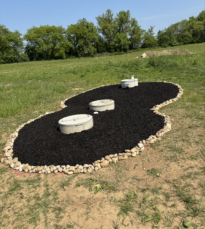 Figure eight garden with completed mulch installation in back yard.